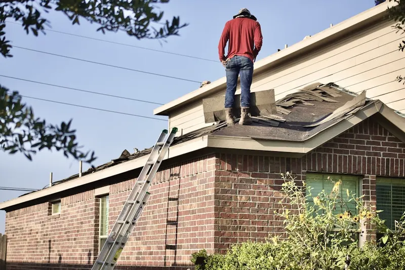 Professional roofer working on a residential roof in River Trails